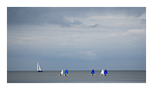photo of sail boats on calm sea