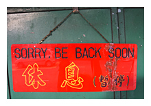 photograph of a sign with Sorry, Be Back Soon text in English and Chinese